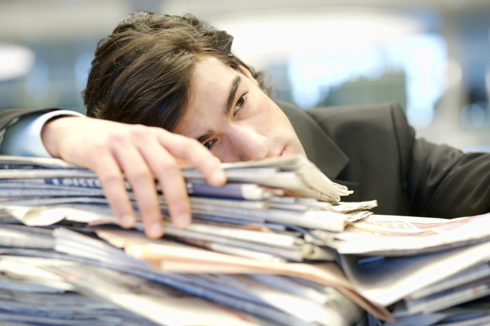 Man struggling with paperwork